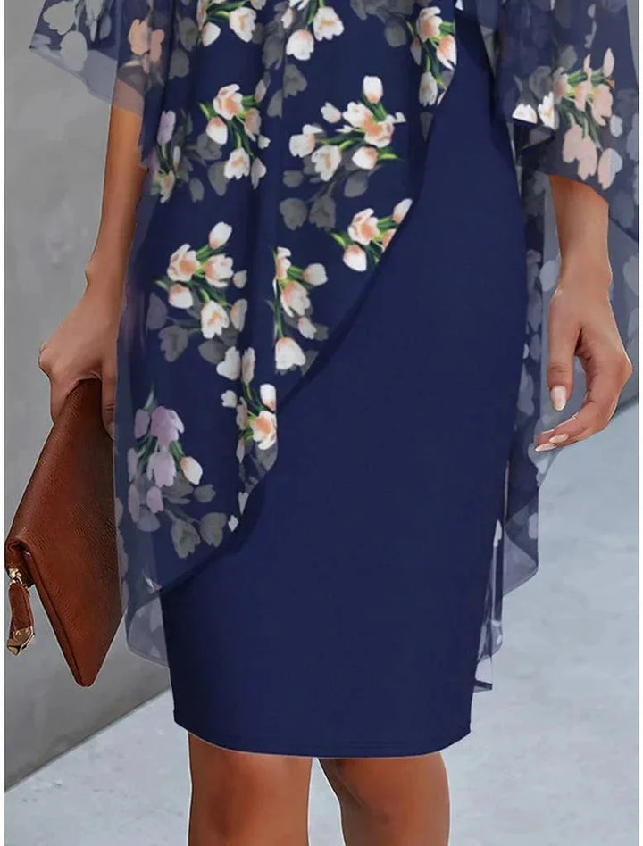 Jacinta dress: Black flowy cape shift with delicate floral overlay in sheer chiffon fabric featuring high neckline and midi…
