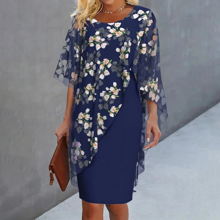 Blue floral overlay shift dress featuring a flowy cape design, perfect for a feminine and elegant look.