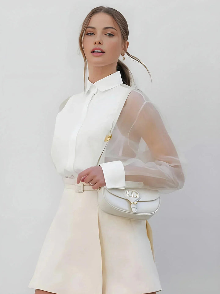 White shift dress with sheer sleeves, perfect for a classic yet elegant look. Made from breathable fabric for comfort all…