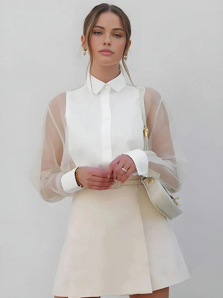 White shift dress with sheer sleeves. Made from soft cotton blend. Elegant and versatile design perfect for everyday wear or…