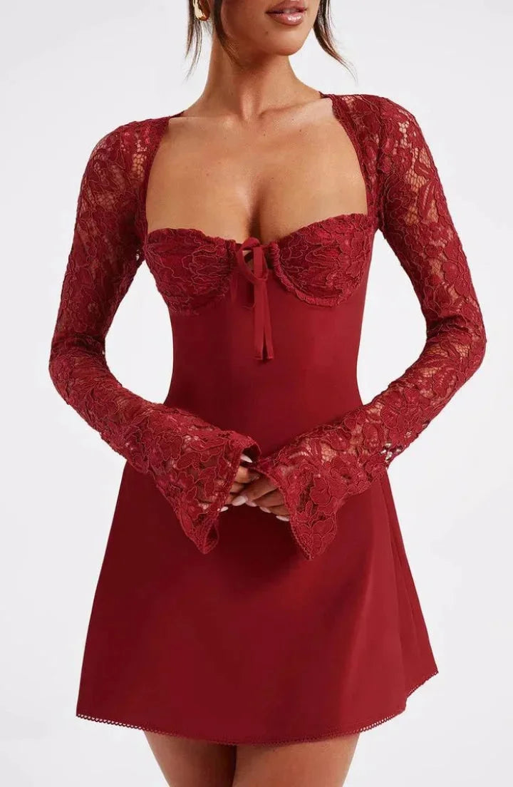 "Lace mini dress in black with long sleeves and bow detail, elegant and feminine design perfect for special occasions."
