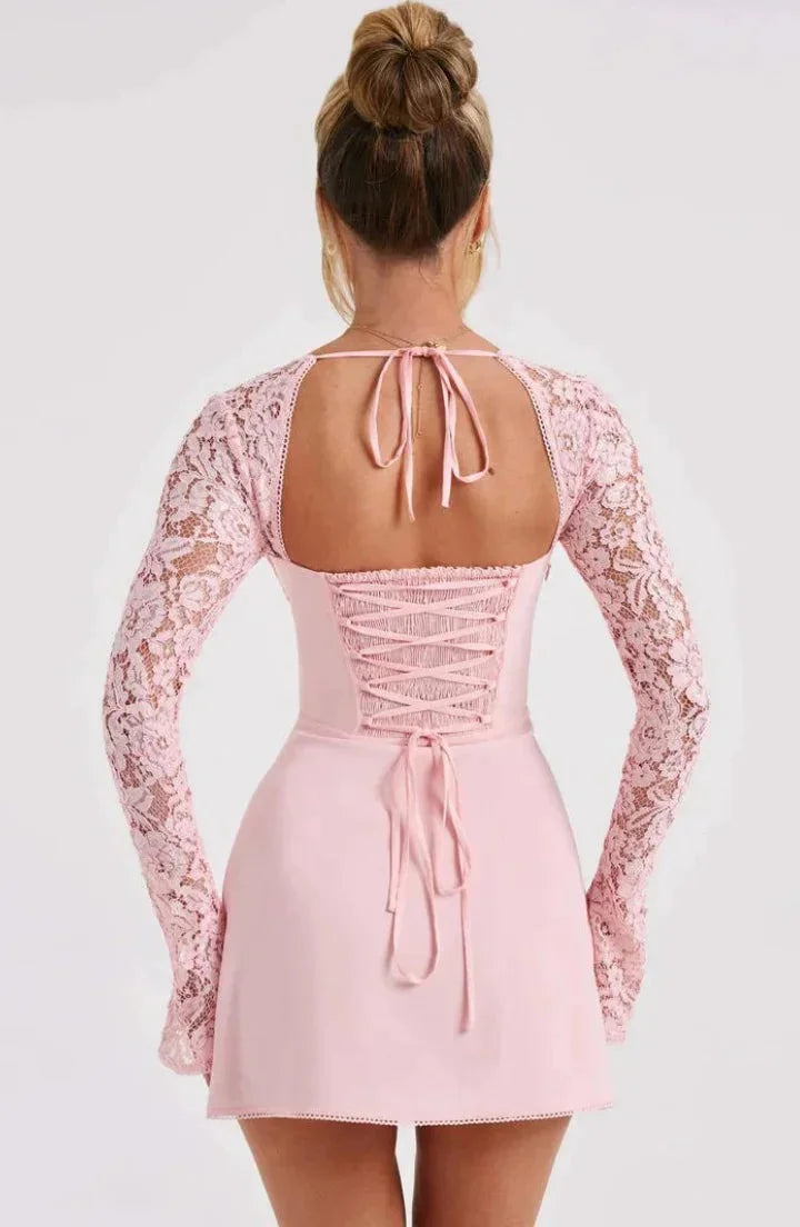 Black lace mini dress with long sleeves and a bow detail. Feminine and elegant for a special occasion.