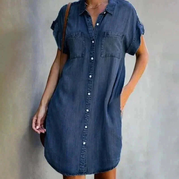 "Dark blue denim shirt dress in relaxed fit with a classic collar and full-length button front. Features long sleeves and…
